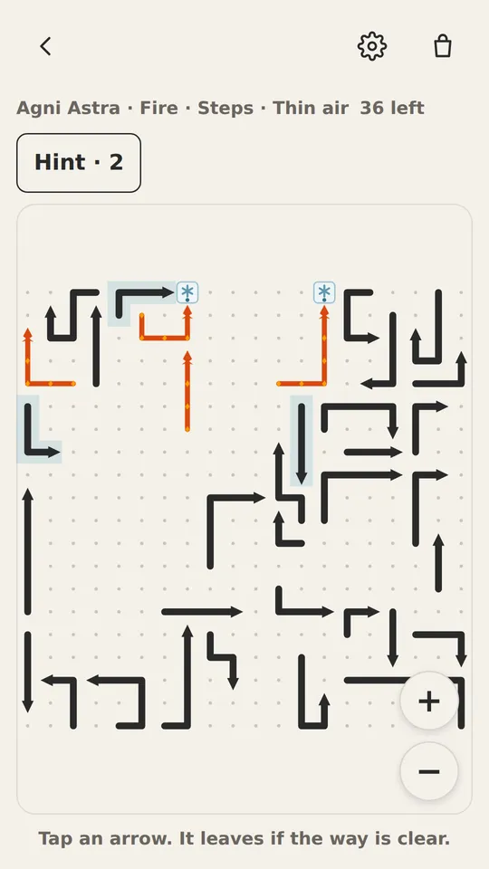 A Flickout board: arrows on a dotted grid, two of them glowing orange